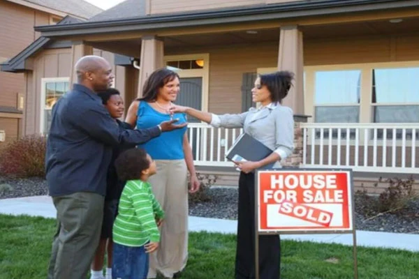 A family receiving the keys to their new home
